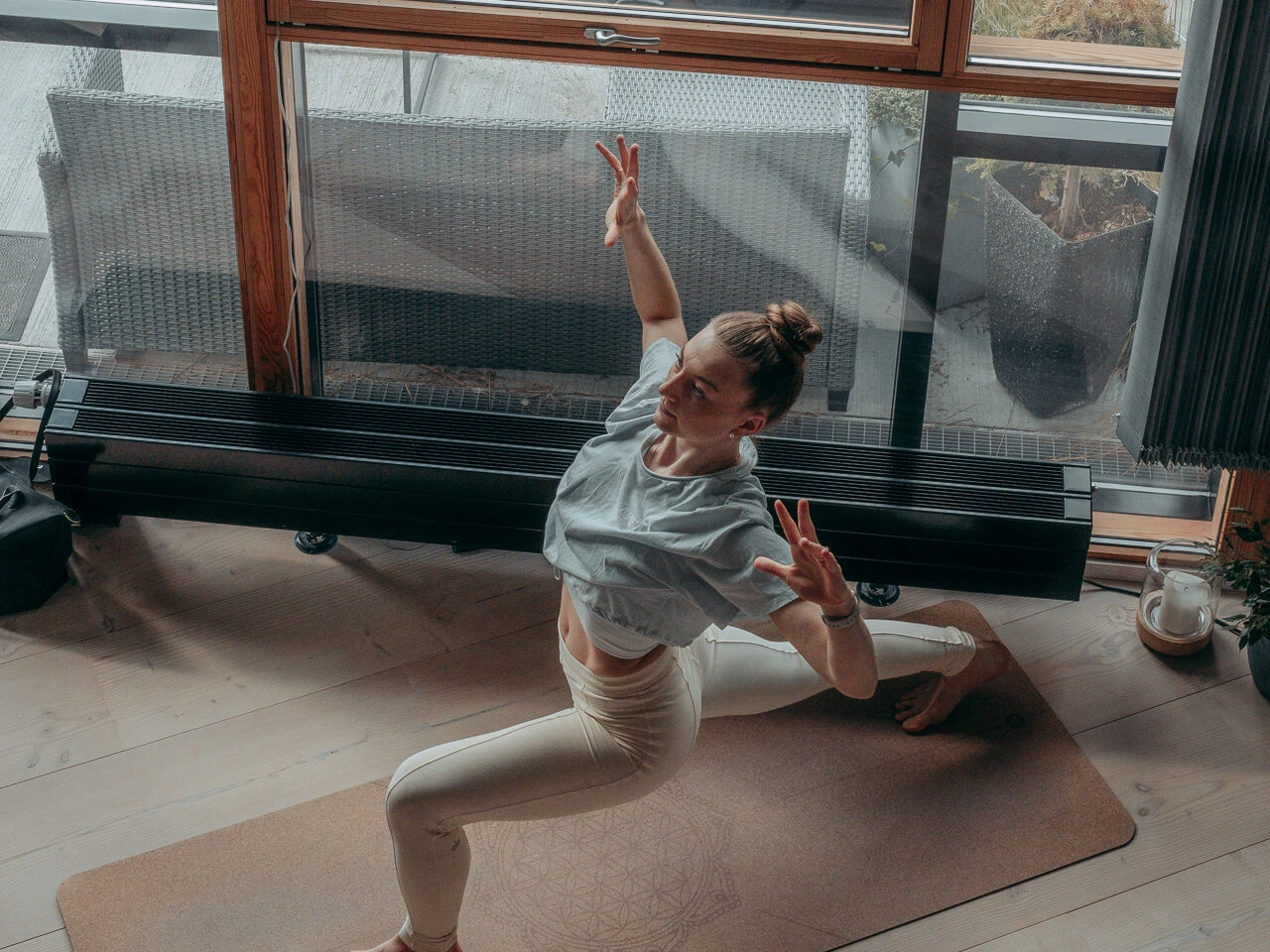 a woman doing yoga in front of a window
